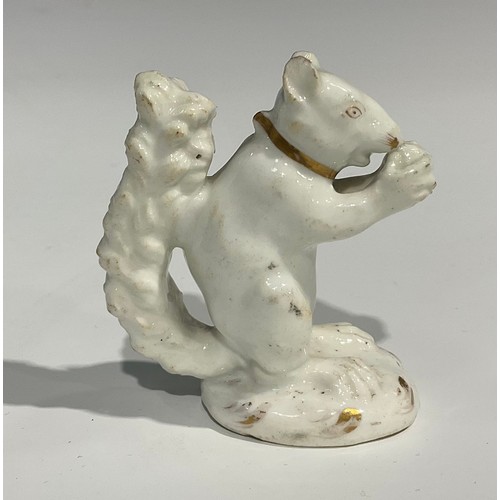 139 - A Rockingham porcelain model, of a squirrel eating a nut, white picked out in gilt, incised marks to... 