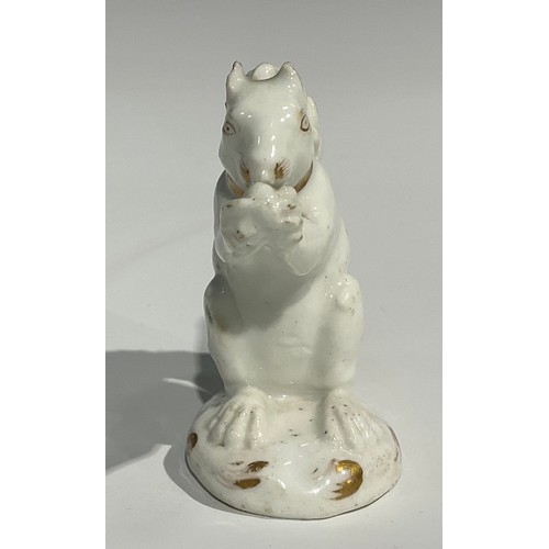 139 - A Rockingham porcelain model, of a squirrel eating a nut, white picked out in gilt, incised marks to... 