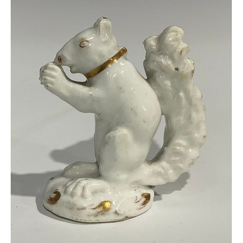 139 - A Rockingham porcelain model, of a squirrel eating a nut, white picked out in gilt, incised marks to... 