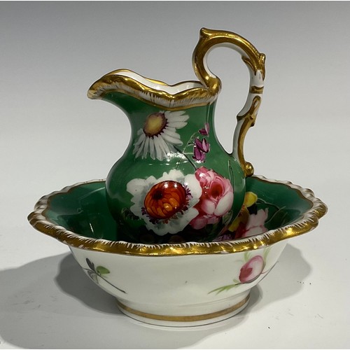 158 - An English porcelain miniature jug and bowl, probably Rockingham, painted with flowers on a green gr... 