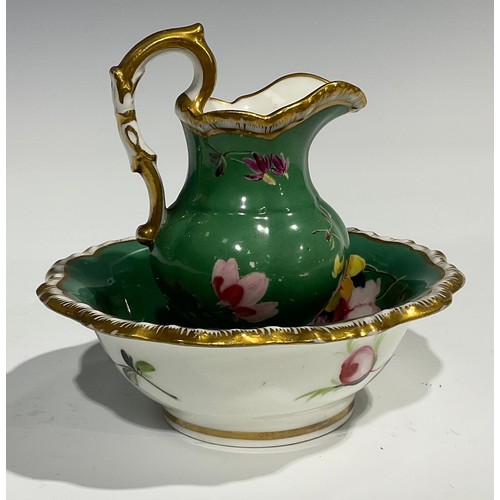 158 - An English porcelain miniature jug and bowl, probably Rockingham, painted with flowers on a green gr... 