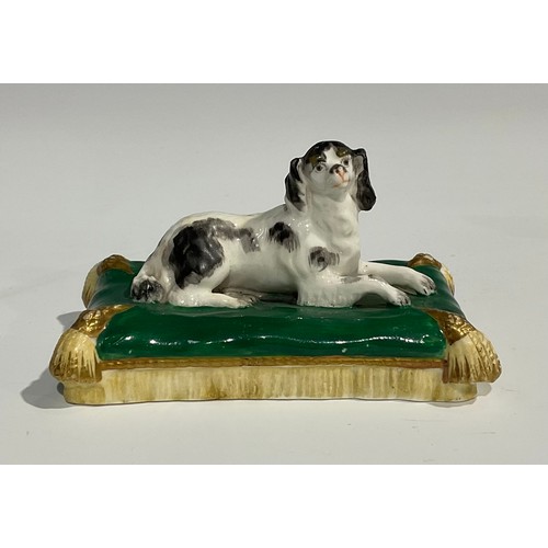 121 - A Derby porcelain model, of a pug, with studded collar, sitting on a shaped oval scroll base, incise... 