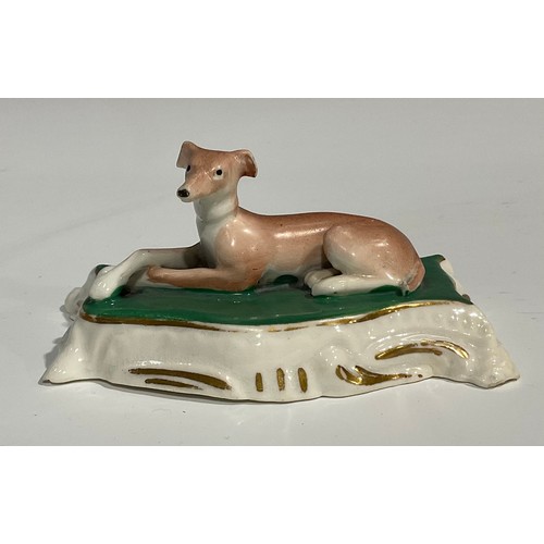 121 - A Derby porcelain model, of a pug, with studded collar, sitting on a shaped oval scroll base, incise... 