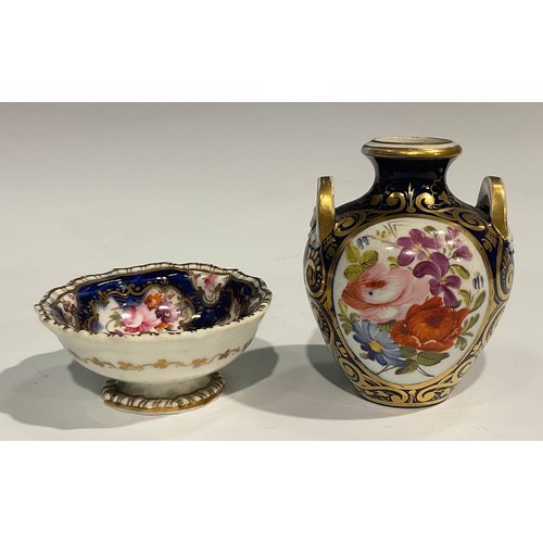 122 - A Derby porcelain two handled ovoid vase, painted with flowers within an oval cartouche, on cobalt b... 