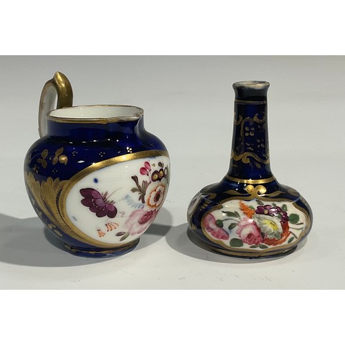 122 - A Derby porcelain two handled ovoid vase, painted with flowers within an oval cartouche, on cobalt b... 