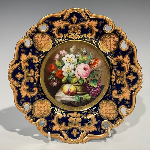 162 - An English porcelain shaped circular plate, the field painted with a basket of flowers and fruit on ... 