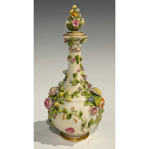 136 - A Rockingham bottle shaped decanter and stopper, profusely encrusted with flowers and foliage and pa... 