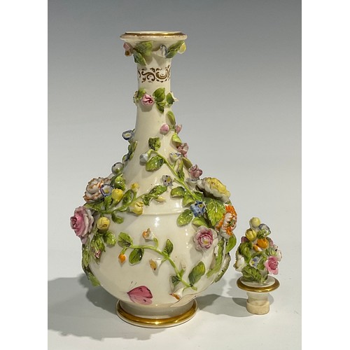 136 - A Rockingham bottle shaped decanter and stopper, profusely encrusted with flowers and foliage and pa... 