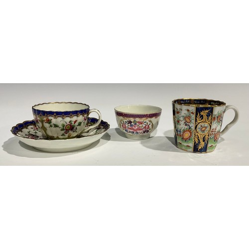 212 - A Worcester fluted teacup and saucer, painted with panels of colourful flowers on a green ground, bl... 