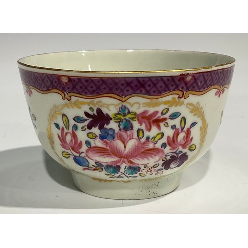 212 - A Worcester fluted teacup and saucer, painted with panels of colourful flowers on a green ground, bl... 