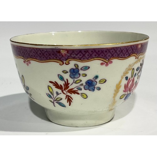 212 - A Worcester fluted teacup and saucer, painted with panels of colourful flowers on a green ground, bl... 