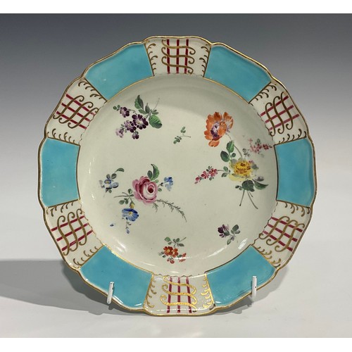 220 - A Worcester shaped circular plate, the field painted with scattered floral sprigs, the border with s... 