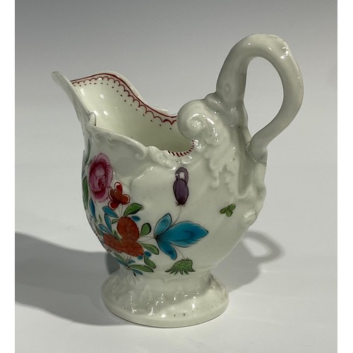 205 - A Worcester dolphin ewer cream jug, in relief with shell moulding, painted in polychrome with flower... 