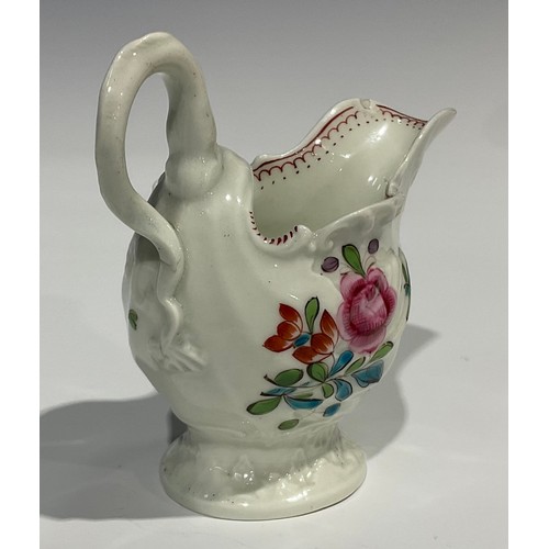 205 - A Worcester dolphin ewer cream jug, in relief with shell moulding, painted in polychrome with flower... 