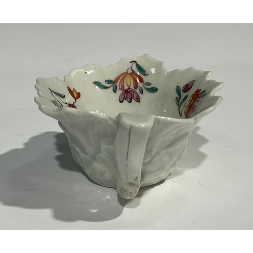 203 - A Worcester butter boat, moulded with overlapping geranium leaves, the interior painted with polychr... 