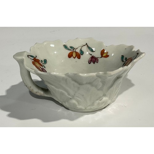 203 - A Worcester butter boat, moulded with overlapping geranium leaves, the interior painted with polychr... 