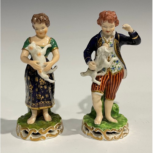 246 - A pair of Derby figures, of a boy and girl, he stands wearing a blue jacket and striped breeches hol... 