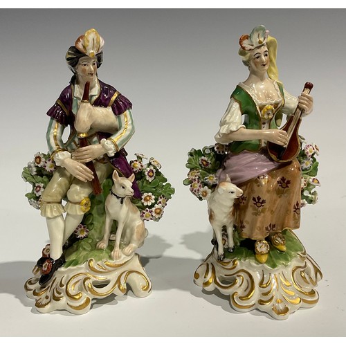 250 - A pair of Derby type figures, of musicians, both in fanciful dress, she with lute, a sheep at her fe... 