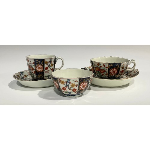 219 - A Worcester Rich Queen's pattern fluted coffee cup and saucer, scroll handle, decorated with alterna... 