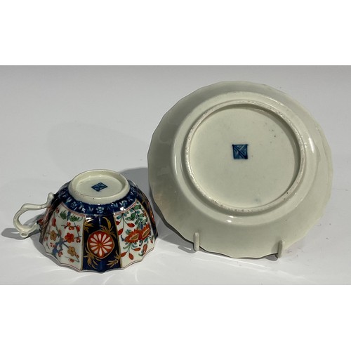 219 - A Worcester Rich Queen's pattern fluted coffee cup and saucer, scroll handle, decorated with alterna... 