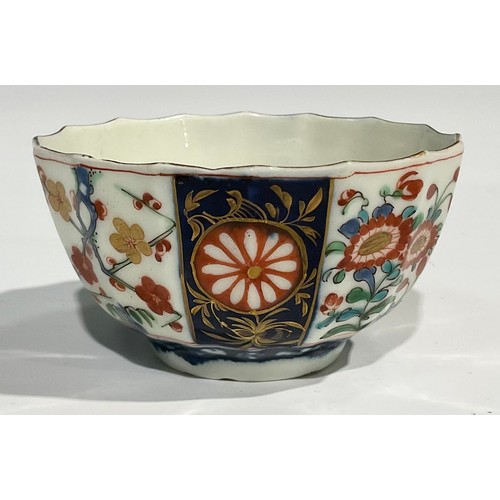 219 - A Worcester Rich Queen's pattern fluted coffee cup and saucer, scroll handle, decorated with alterna... 