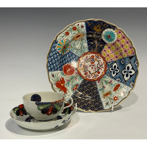 215 - A Worcester Old Japan Fan pattern teacup and saucer, painted in the Imari palette, picked out in gil... 