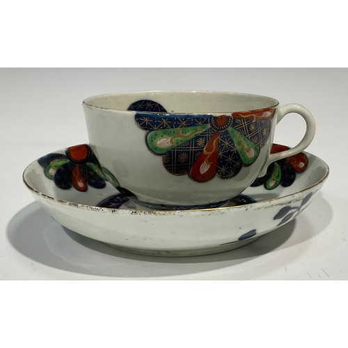 215 - A Worcester Old Japan Fan pattern teacup and saucer, painted in the Imari palette, picked out in gil... 