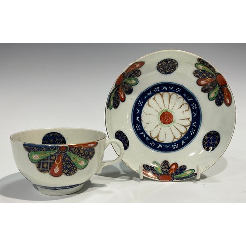 215 - A Worcester Old Japan Fan pattern teacup and saucer, painted in the Imari palette, picked out in gil... 