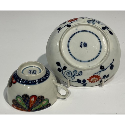 215 - A Worcester Old Japan Fan pattern teacup and saucer, painted in the Imari palette, picked out in gil... 