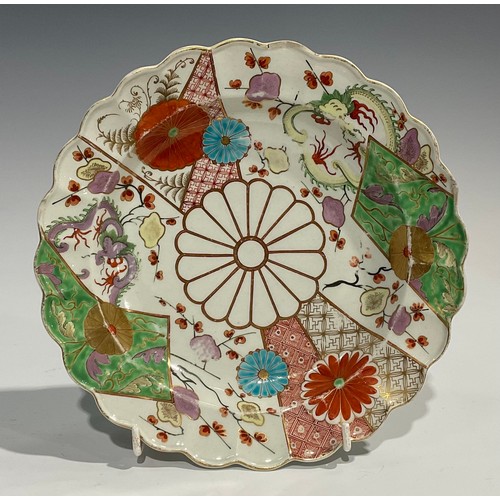 216 - A Worcester Old Mosaic pattern shaped circular dish, painted and gilded with alternating flowering p... 