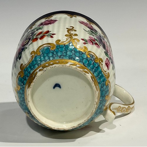 211 - A Worcester fluted teacup and saucer, circular cartouches painted with lakeside scenes, edged with a... 