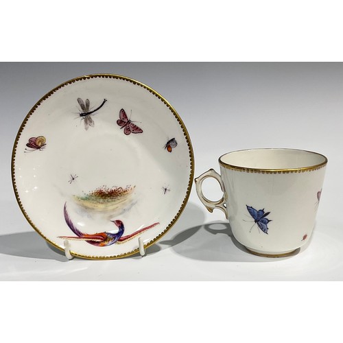 211 - A Worcester fluted teacup and saucer, circular cartouches painted with lakeside scenes, edged with a... 