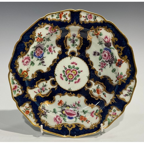 202 - A set of four Worcester shaped circular plates, painted with flowers and sprigs within gilt fan and ... 