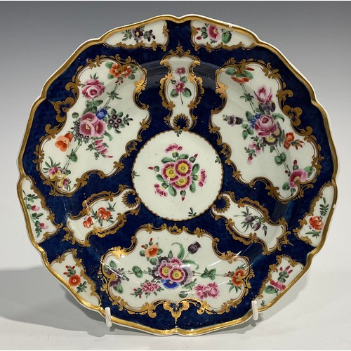 202 - A set of four Worcester shaped circular plates, painted with flowers and sprigs within gilt fan and ... 