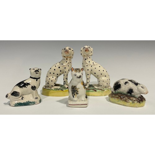 333 - A pair of Staffordshire Dalmations, seated to the left and right, gilt collars and chains, oval moss... 