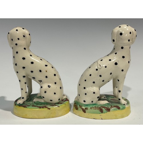 333 - A pair of Staffordshire Dalmations, seated to the left and right, gilt collars and chains, oval moss... 