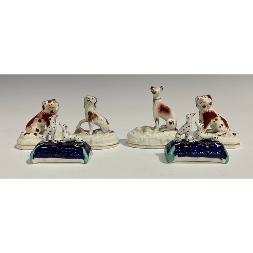 334 - A pair of Staffordshire Spaniels, seated to the left and right, picked out in rust brown, gilt lined... 