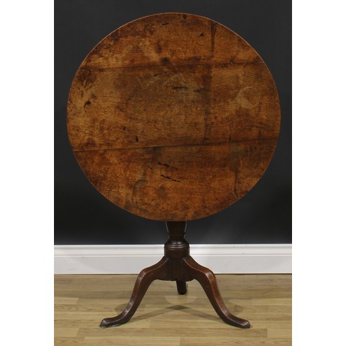 2122 - A George III oak tripod occasional table, circular tilting top, turned column, cabriole legs, pointe... 