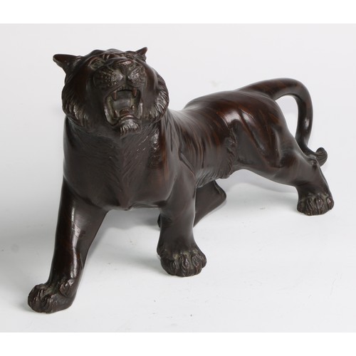 415 - Japanese School (Meiji period), a brown patinated bronze, of a tiger, 27cm long