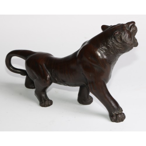 415 - Japanese School (Meiji period), a brown patinated bronze, of a tiger, 27cm long