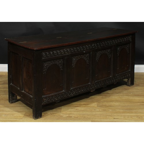 2152 - A large 17th century oak blanket chest, anachronistic hinged top above a four panel front, each carv... 