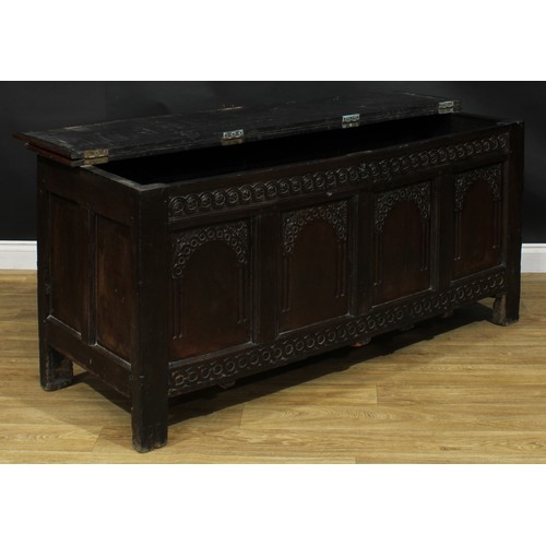 2152 - A large 17th century oak blanket chest, anachronistic hinged top above a four panel front, each carv... 