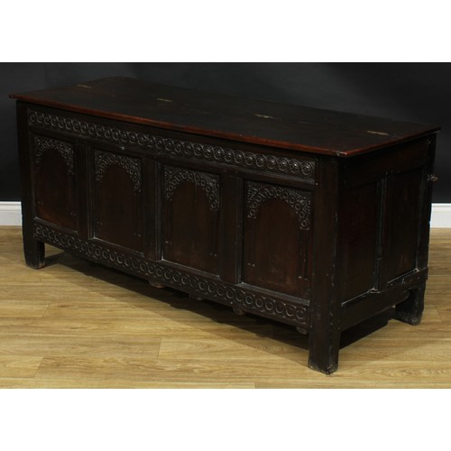 2152 - A large 17th century oak blanket chest, anachronistic hinged top above a four panel front, each carv... 