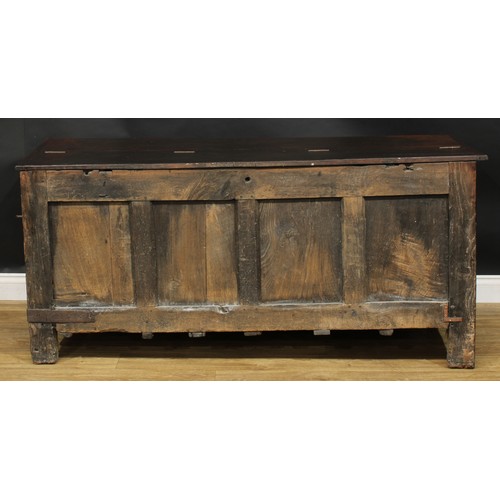 2152 - A large 17th century oak blanket chest, anachronistic hinged top above a four panel front, each carv... 