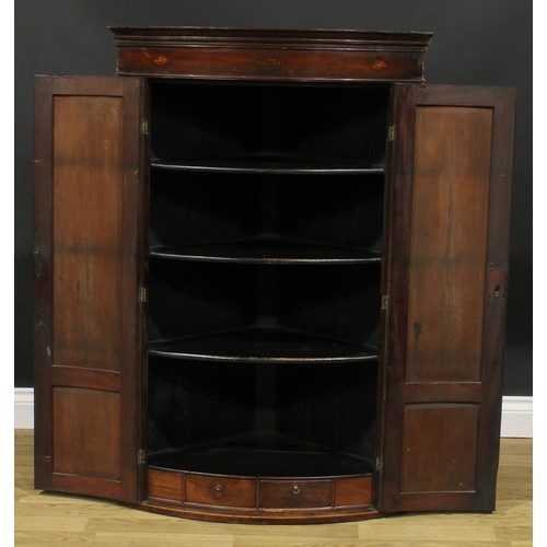 2117 - A George III mahogany bowfront corner cabinet, moulded cornice above a parcel-marquetry frieze inlai... 