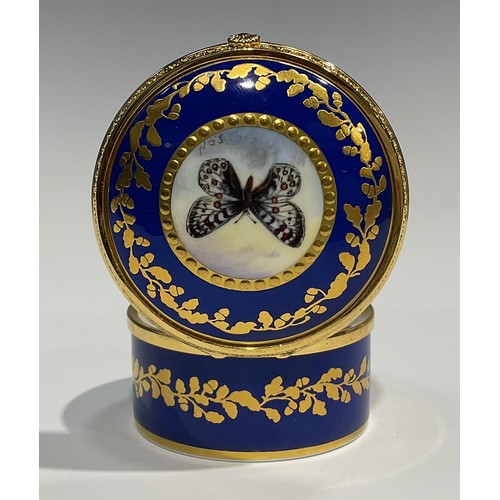 274 - A Lynton porcelain circular table box, painted by Stefan Nowacki, signed, with a butterfly, within a... 