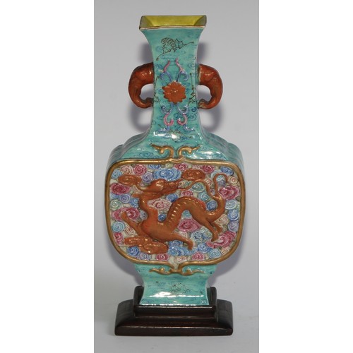 406 - A Chinese slab-sided ovoid vase, of Archaic form, moulded with dragons amongst scrolling clouds, gla... 