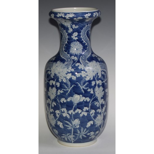 443 - A large Chinese ovoid vase, painted in tones of underglaze blue with dragons amongst flowers and fol... 