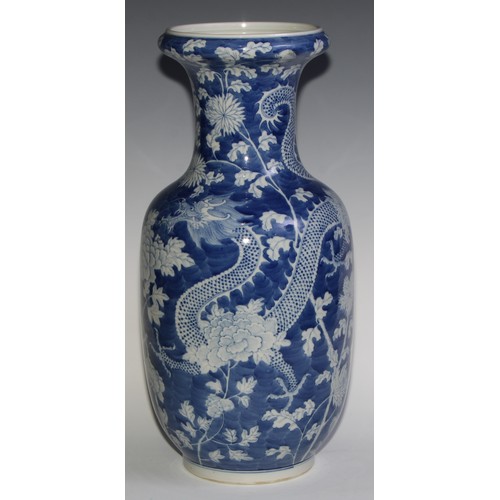 443 - A large Chinese ovoid vase, painted in tones of underglaze blue with dragons amongst flowers and fol... 