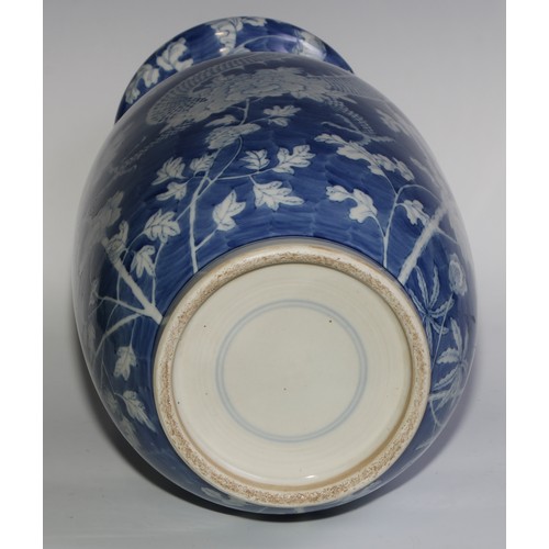 443 - A large Chinese ovoid vase, painted in tones of underglaze blue with dragons amongst flowers and fol... 